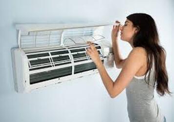 Girl with broken AC unit