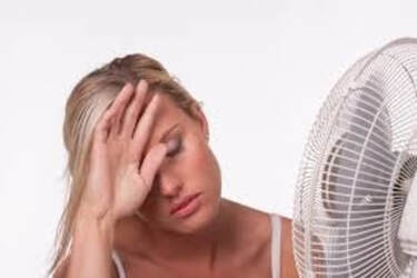 Woman hot in front of fan 